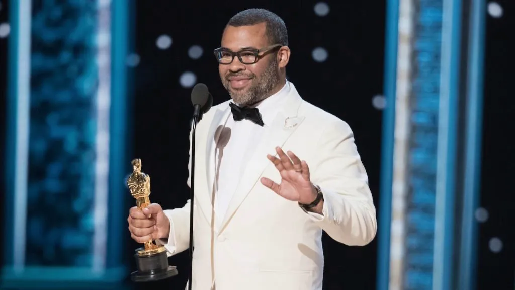 A still image of Jordan Peele at the Oscars.
