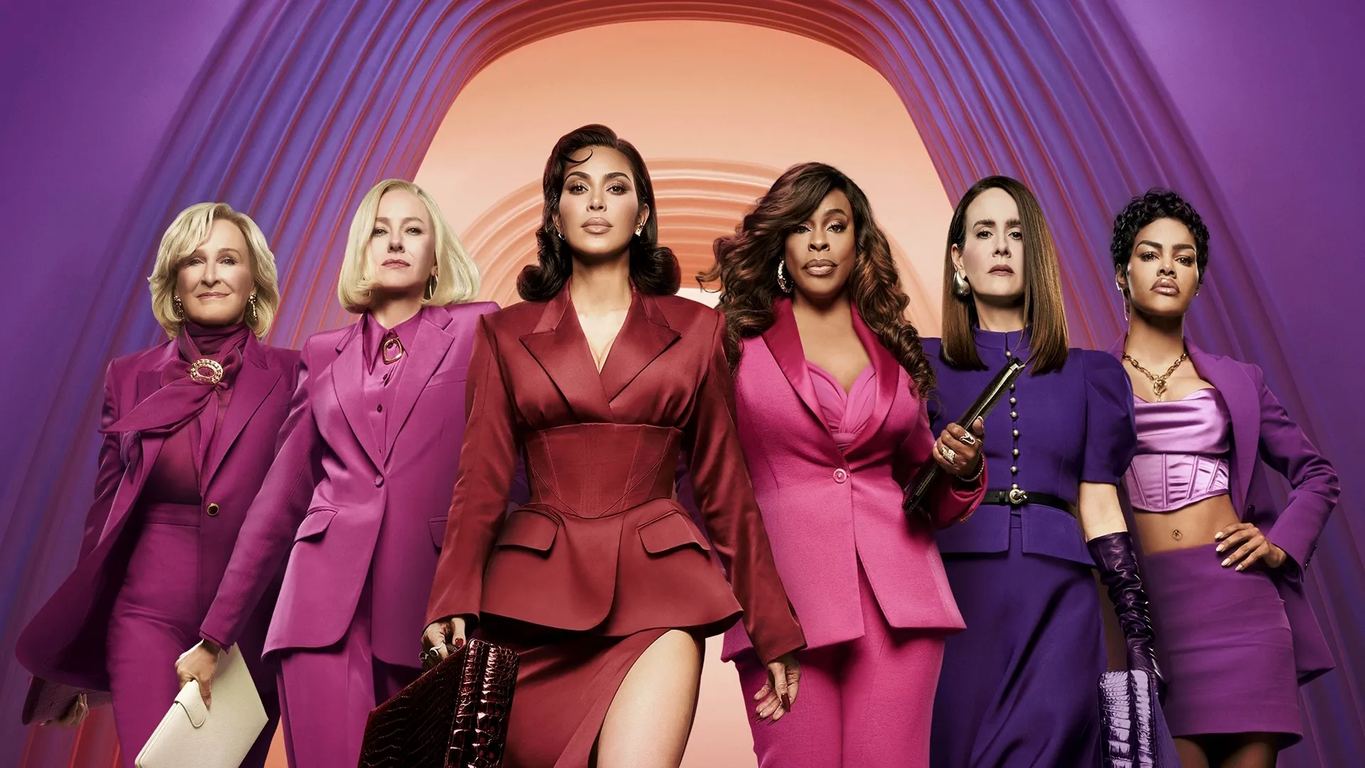 Six women stand confidently shoulder-to-shoulder in vibrant magenta and purple suits against a modern arched architectural background.