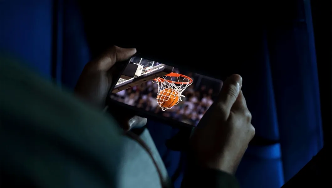 Person watching basketball game on their mobile device