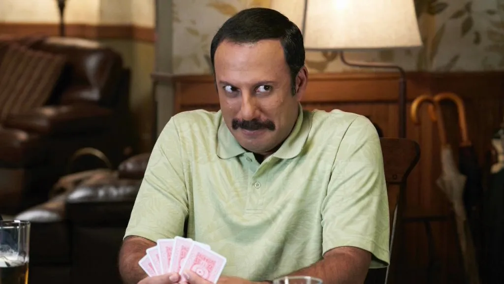 A still image of Rizwan Manji as Ray Butani in an episode of Schitt’s Creek.